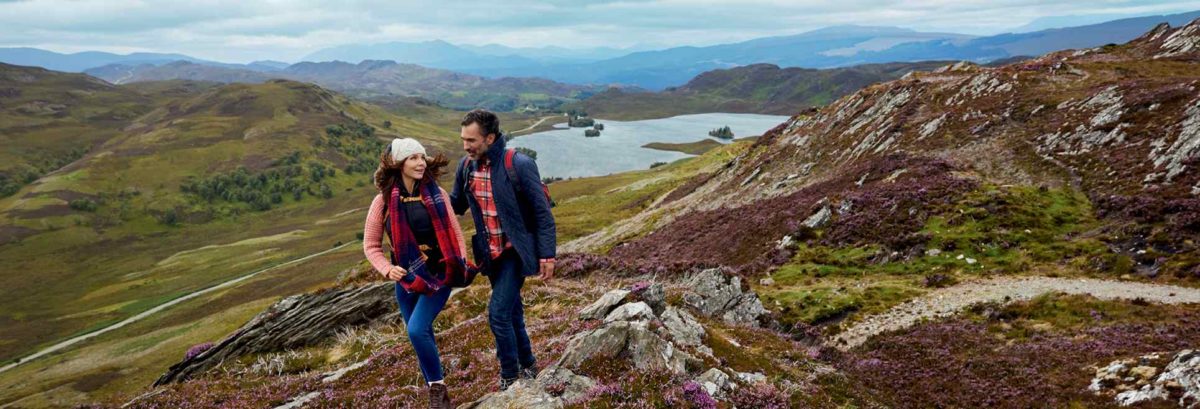 Couple hiking on the Loch Ness 360 Trail near Suidhe Viewpoint