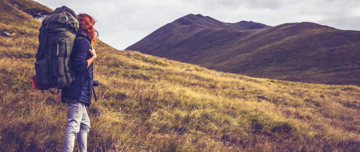 Backpacker looking over a hillside