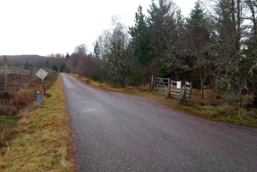 Small road on the Great Glen Way with waymarker near Abriachan