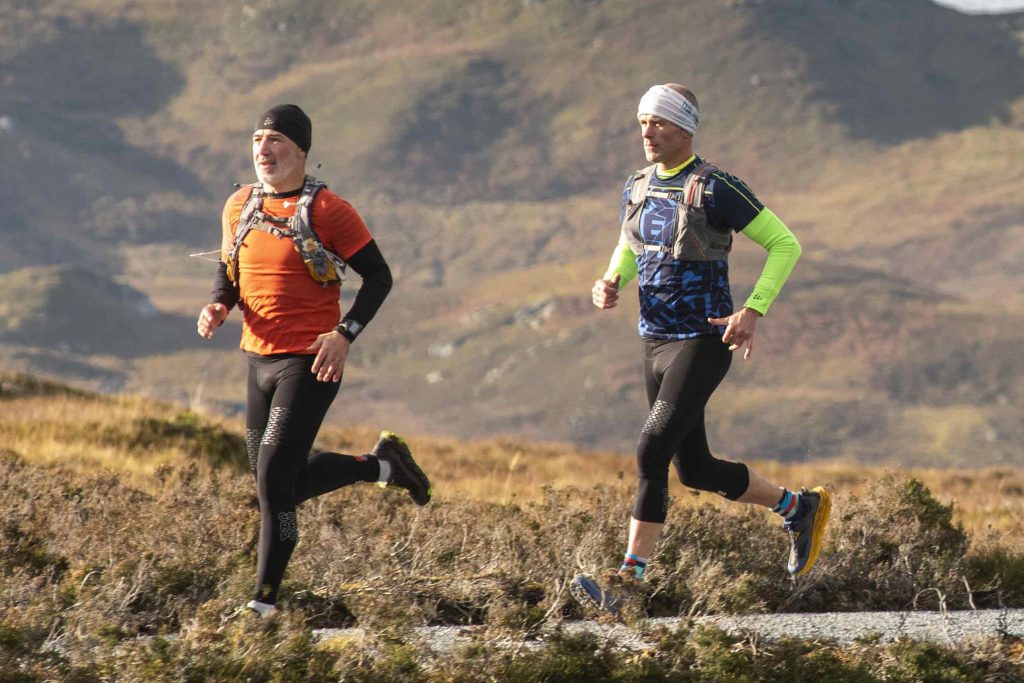 Two men running near Loch Ness